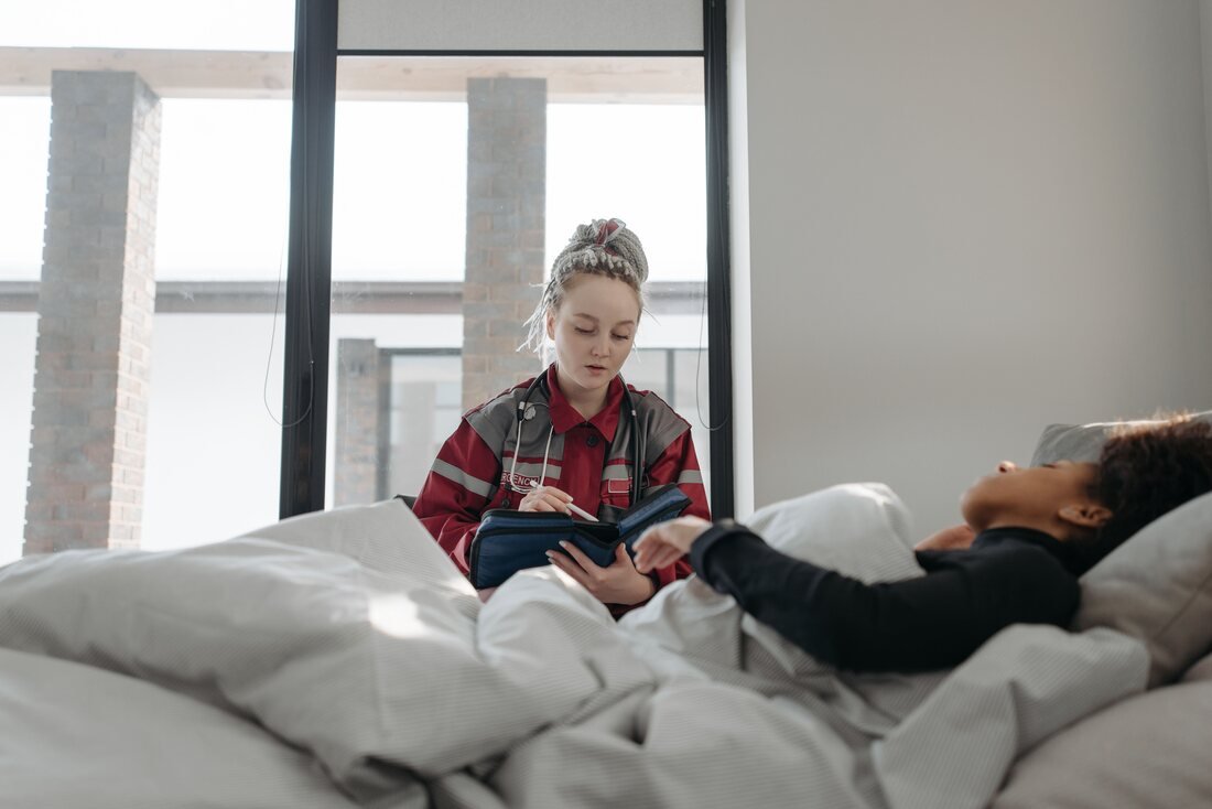 Nurse monitoring a patient resting at home